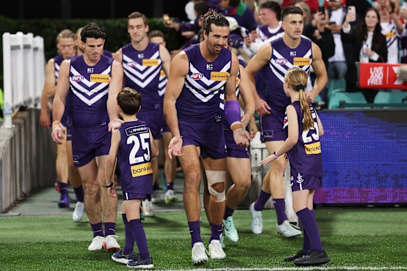 Alex Pearce leads his team on to the SCG for the preliminary final. 