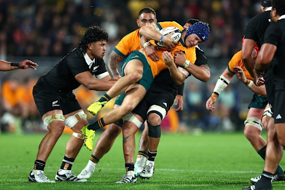Josh Flook is tackled during a Bledisloe Cup match against the New Zealand All Blacks.