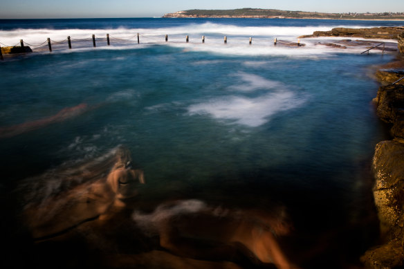 Swimmers at Mahon Pool in Maroubra on a warm autumn morning.