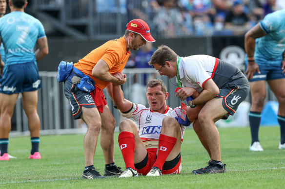 Tom Gilbert goes down in the Dolphins’ 
trial loss against the Warriors.