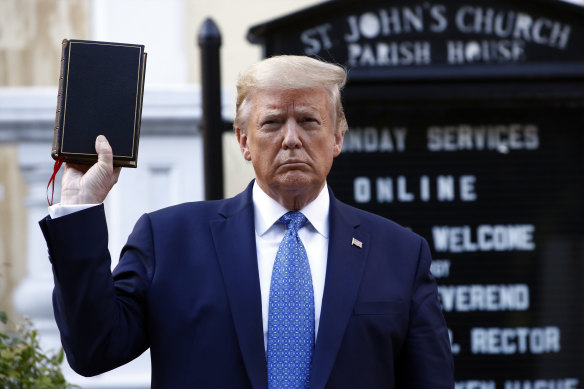 Donald Trump holds up a Bible outside a Washington DC church damaged during Black Lives Matter protests last year.