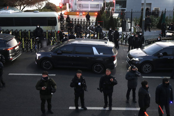 Members of the Corruption Investigation Office for High-ranking Officials arrive in front of impeached South Korean President Yoon Suk Yeol’s official residence in Seoul.