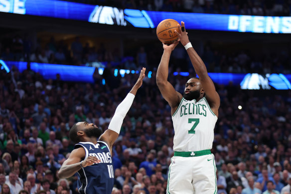 Jaylen Brown shoots over Kyrie Irving.