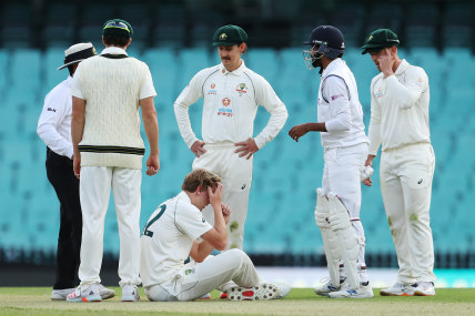 All-rounder Cameron Green goes down after being struck in the head while bowling at the SCG on Friday.