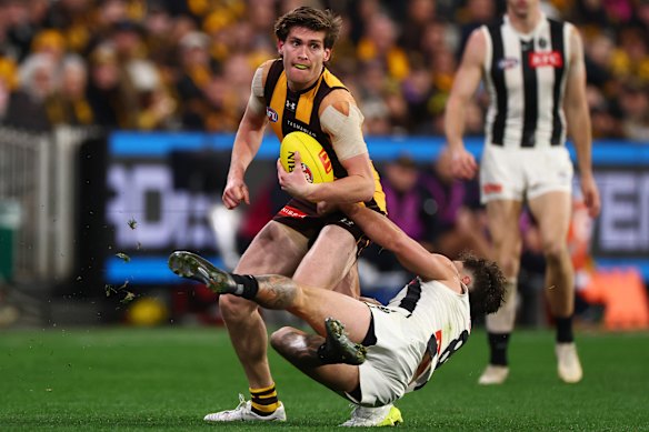 Will Day of the Hawks is tackled by Lachie Schultz of the Magpies.
