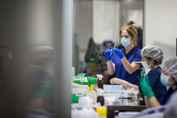 Staff prepare vaccine doses at the Melbourne Convention and Exhibition Centre. 