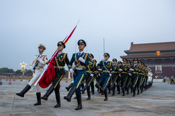 The Guard of Honor of the Chinese People’s Liberation Army escorts the Chinese national flag in Beijing on China’s Army Day on August 1, 2022, 