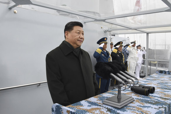 Chinese President Xi Jinping reviews a naval parade.