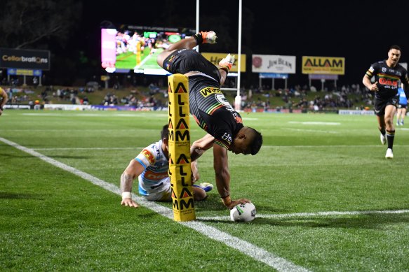 Head over heels: Brian To'o scores an acrobatic try against the Titans in 2019. 