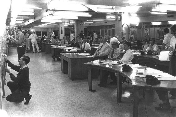 Herald reporters watch as election results are posted in the newsroom in the early ’70s.