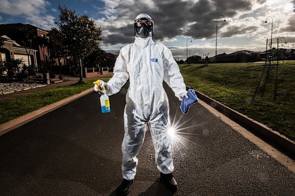 Army of cleaners spray and wipe the way back to normal office lives