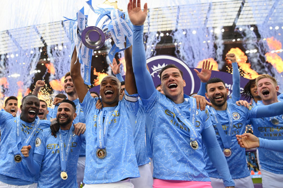 Fernandinho lifts the trophy for Manchester City.