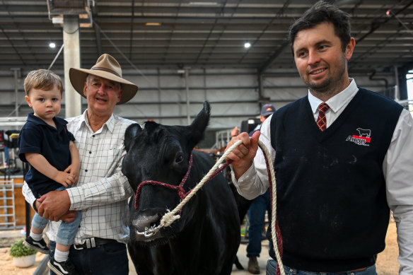 Peter Collins, with his son Brodie, grandson Eddie and Cydie the prize-winning cow at the Melbourne Royal Show on Thursday.
