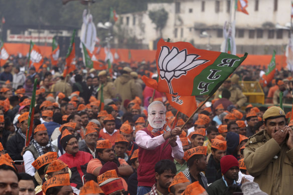 A man wearing a mask of Indian Prime Minister Narendra Modi at a rally in New Delhi.