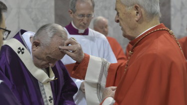 Cardinal Jozef Tomko puts ashes on Pope Francis' forehead, at the Basilica of Saint Sabina in Rome.