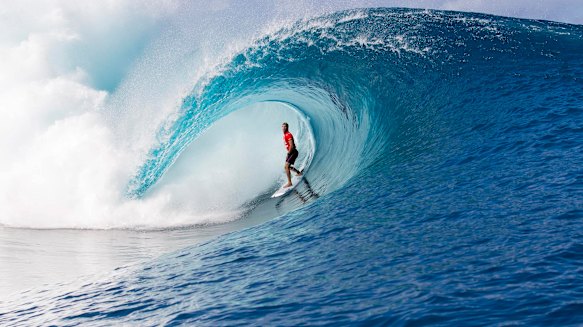 Working man: Mick Fanning plying his trade at Teahupo'o in Tahiti.