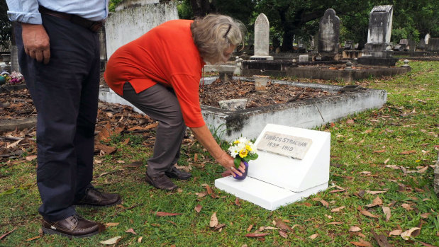 Carmel Searle laying flowers on the grave of her great-great-grandfather.