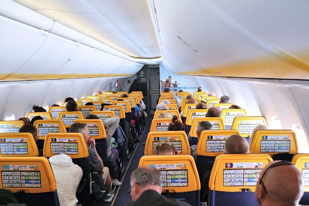 Cabin interior of Boeing 737-800 passenger airplane of low cost airline Ryanair operating from Italy.