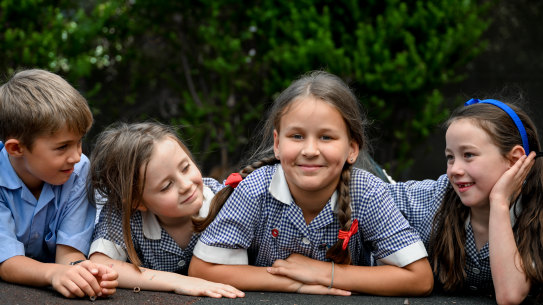 Leza Solovei (centre) fled Ukraine last April and has been welcomed by students at Sacred Heart Primary School in Kew.