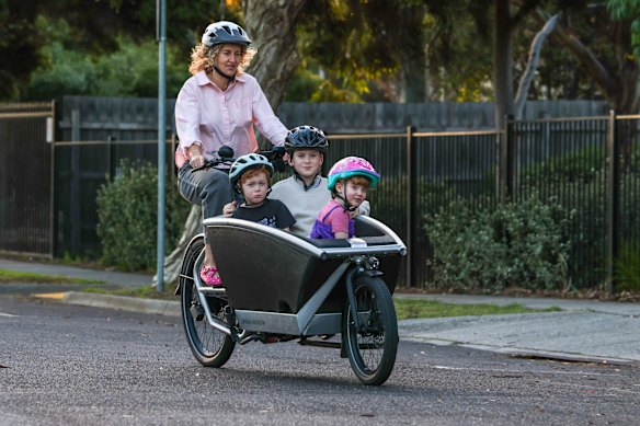 Emily Hehir and her three children: Eden, Jonas and Leila being pedalled to school in an electric cargo bike. 