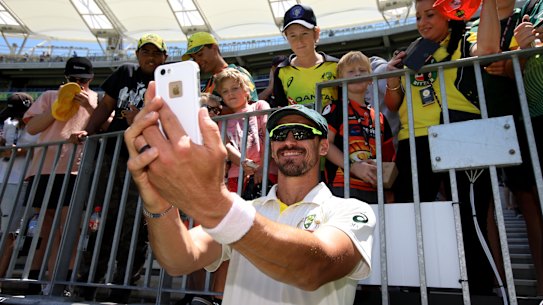 Smile: Mitchell Starc takes a selfie with young fans after the clinical finish in Perth.