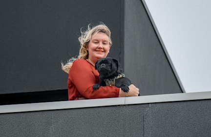 Soldiering on: Nicola Clement with Vernon on her Ariele building balcony.