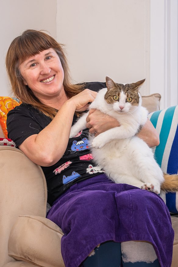 Jodie Stewart with Poppy, one of her two felines, at her home in the NSW Bega Valley.
