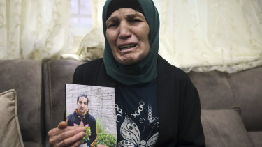 Rana, mother of Iyad Halak, 32, holds his photo at their home in East Jerusalem's Wadi Joz, Saturday, May 30, 2020.