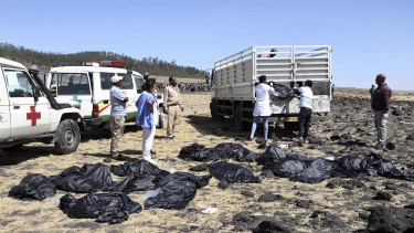 Rescuers remove body bags from the scene of an Ethiopian Airlines flight that crashed shortly after takeoff at Hejere near Bishoftu,  south of Addis Ababa, in Ethiopia.