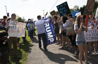 Divisive: Trump supporters clash with anti-Trump protesters outside a rally in Ohio on Saturday.