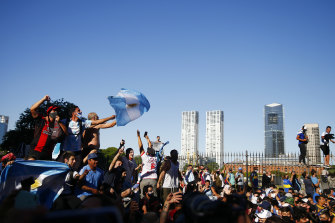 Fans wave flags as Diego Maradona lies in state at the presidential palace in Buenos Aires.