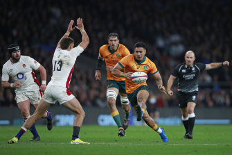 Australiaâ€™s Len Ikitau chips the ball.