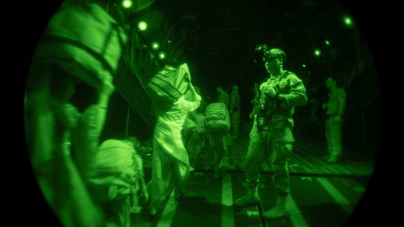 US Air Force security team assists evacuees boarding a C-17 transport plane at Hamid Karzai International Airport in Kabul, Afghanistan.