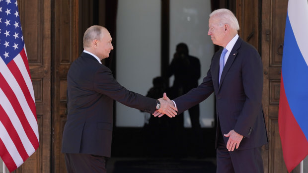 Russian President Vladimir Putin and US President Joe Biden shake hands before meeting in Geneva, Switzerland. 