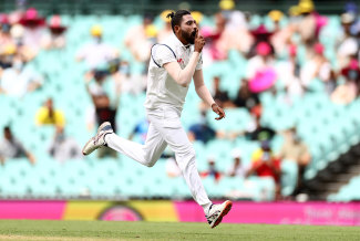 Mohammed Siraj celebrates taking Warner's wicket early on day one.