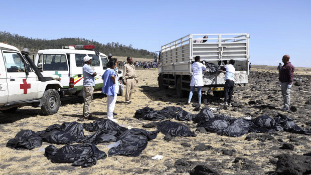 Rescuers remove body bags from the scene of an Ethiopian Airlines flight that crashed shortly after takeoff at Hejere near Bishoftu,  south of Addis Ababa, in Ethiopia.