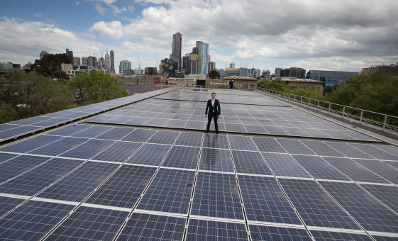 Cr Nick Reece atop a huge solar array at the University of Melbourne.