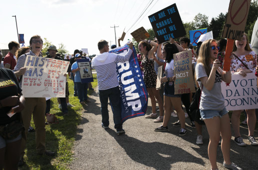 Divisive: Trump supporters clash with anti-Trump protesters outside a rally in Ohio on Saturday.
