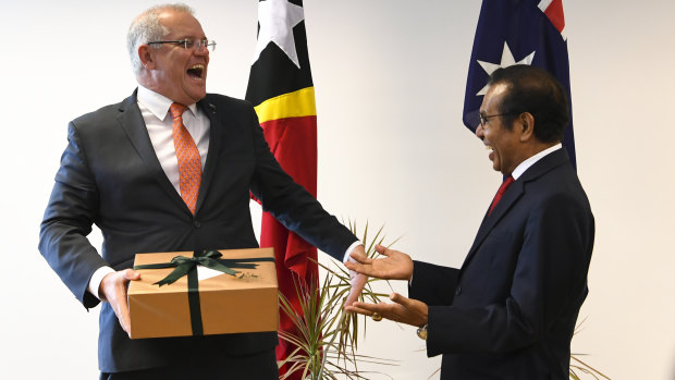 Australian Prime Minister Scott Morrison and Prime Minister of East Timor Taur Matan Ruak exchange presents at the end of a bilateral meeting in Dili.