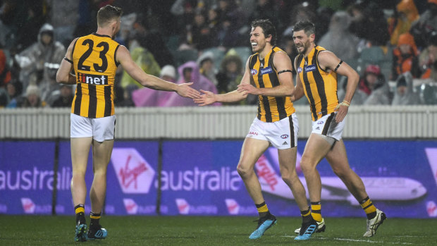 Hawthorn's Isaac Smith (centre) after booting a goal.