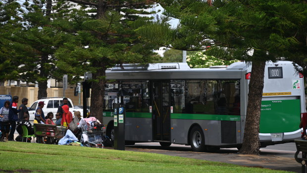 Rough sleepers wait to  board a Transperth bus that will take them to temporary accommodation. 