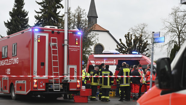 Police and rescue workers stand next to the scene of a car crash at the carnival parade in Volkmarsen, central Germany.