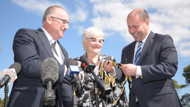 Swan MP Steve Irons presents Treasurer and Carlton supporter Josh Frydenberg with a West Coast Eagles tie at an announcement of $20 million for the South Perth Recreation and Aquatic Facility near Curtin University, with South Perth Mayor Sue Doherty.
