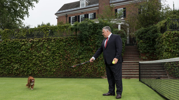 Joe Hockey on the tennis court at the ambassador's residence.