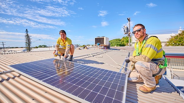 Gas plant electricians Ciaran Fallon and Tom Willis at their side project installing rooftop solar. 