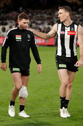 Taylor Adams is consoled by teammate Jack Madgen.