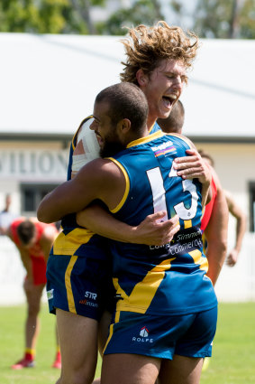 Canberra Demons player Kel Evans celebrates with Tom Faul.