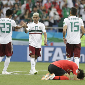 Mexican players celebrate after their victory.