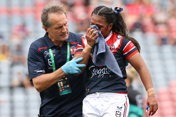 Nathan Gibbs tends to Roosters player Taylor-Adeline Mapusua.