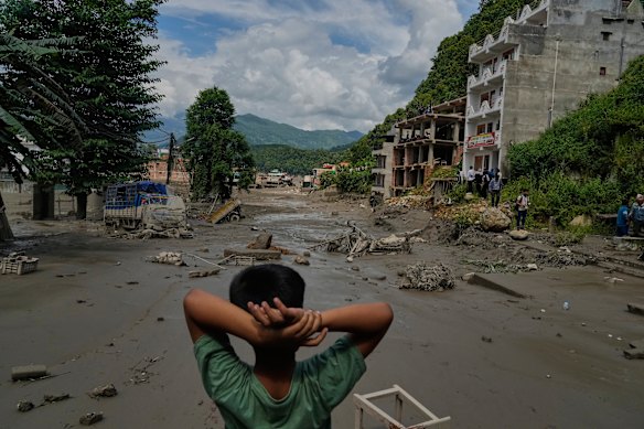 A boy looks at the devastation along the Trishuli River in Nepal’s Nuwakot district.